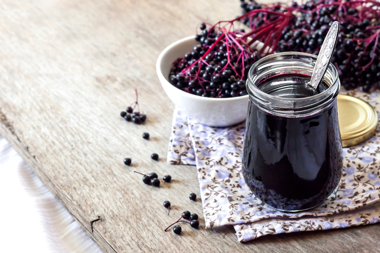 Homemade black elderberry syrup in glass jar